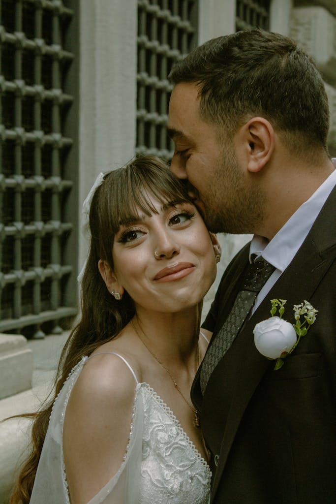 Bride and groom share a tender moment in an outdoor wedding photoshoot.