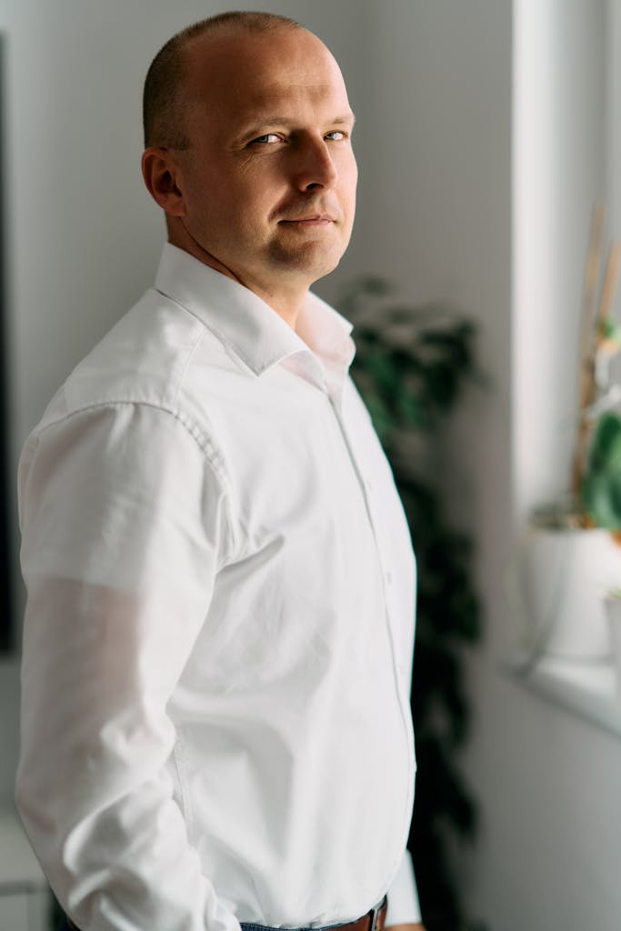 Businessman standing by a window in an office, Bratislava.