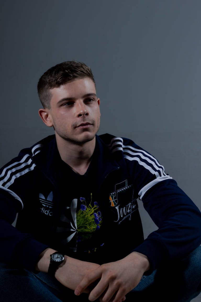 Portrait of a young man wearing a sport jacket in a studio setting indoors.